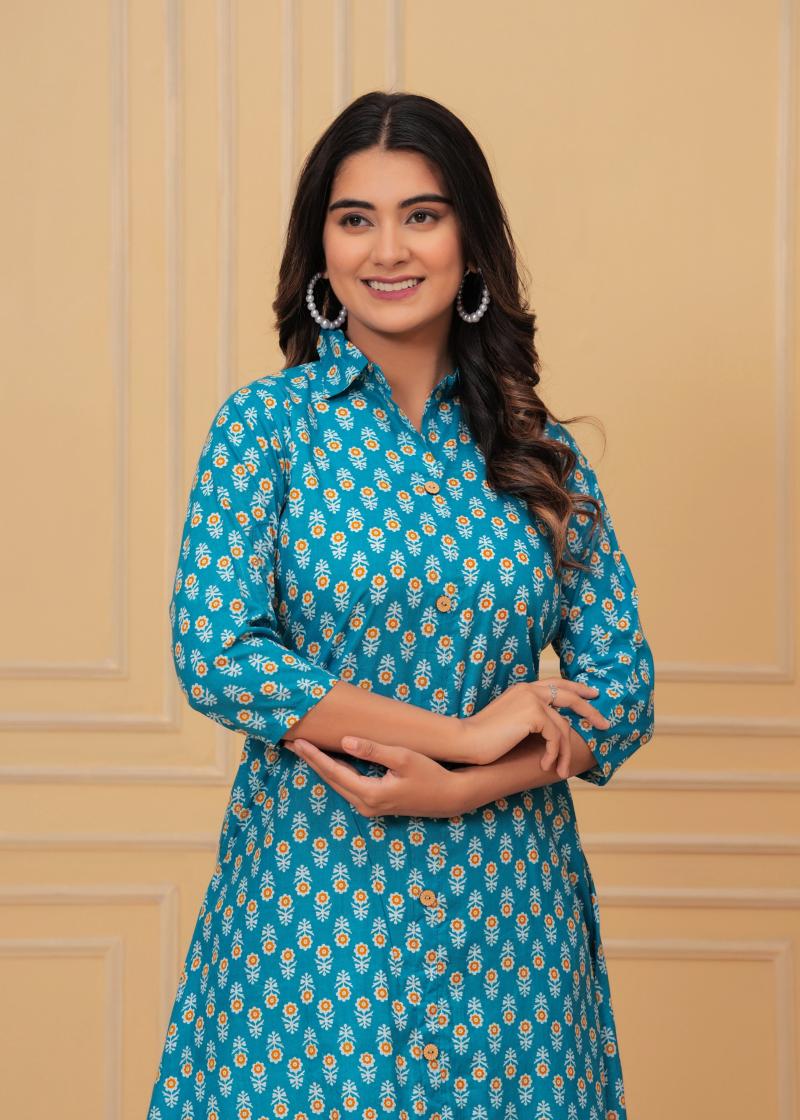 Woman wearing a blue floral dress against a beige wall